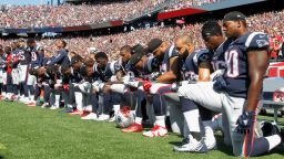 Members of the New England Patriots kneel during the National Anthem before a game.