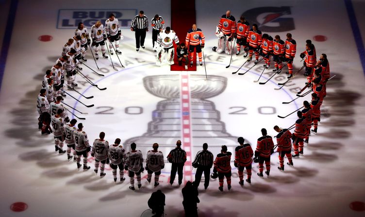 Matt Dumba of the Minnesota Wild <a href="index-1026.html" target="_blank">kneels during the US National Anthem</a> as it is played before an NHL game in Edmonton, Alberta, on August 1. Dumba, a member of the Hockey Diversity Alliance, gave a short speech before kneeling. He is circled by members of the Edmonton Oilers and the Chicago Blackhawks, who were about to play on the first day of the NHL's return.