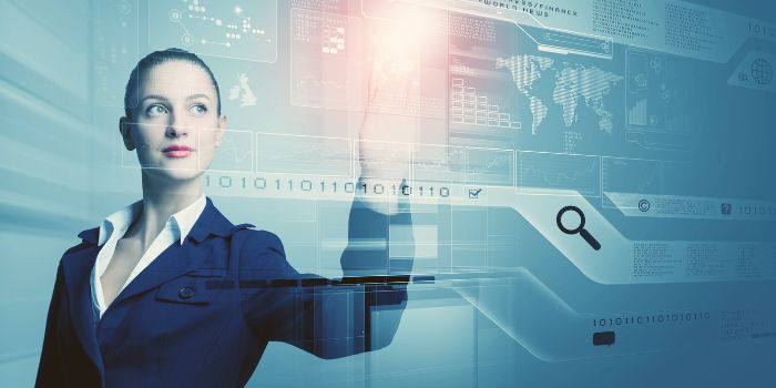 Woman looking up and pointing at touchscreen representing disruptive innovation technology