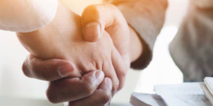 Two men shaking hands representing best erm software