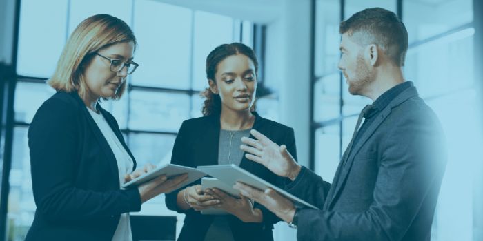 Incident management team represented by one male two females review incident reports