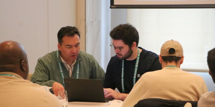 A resolver solution engineer assisting a corporate security and investigations customer with software questions during a breakout session at ascend 2025.